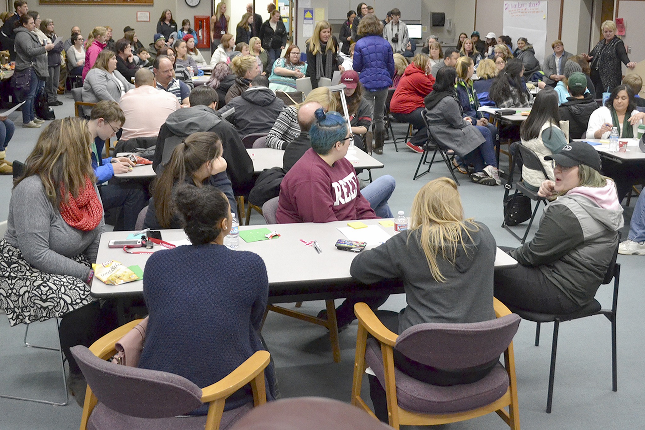 Superintendent Becky Berg, right, talks to a packed crowd in the school board room at the Marysville School District office. (Steve Powell/Staff Photo)
