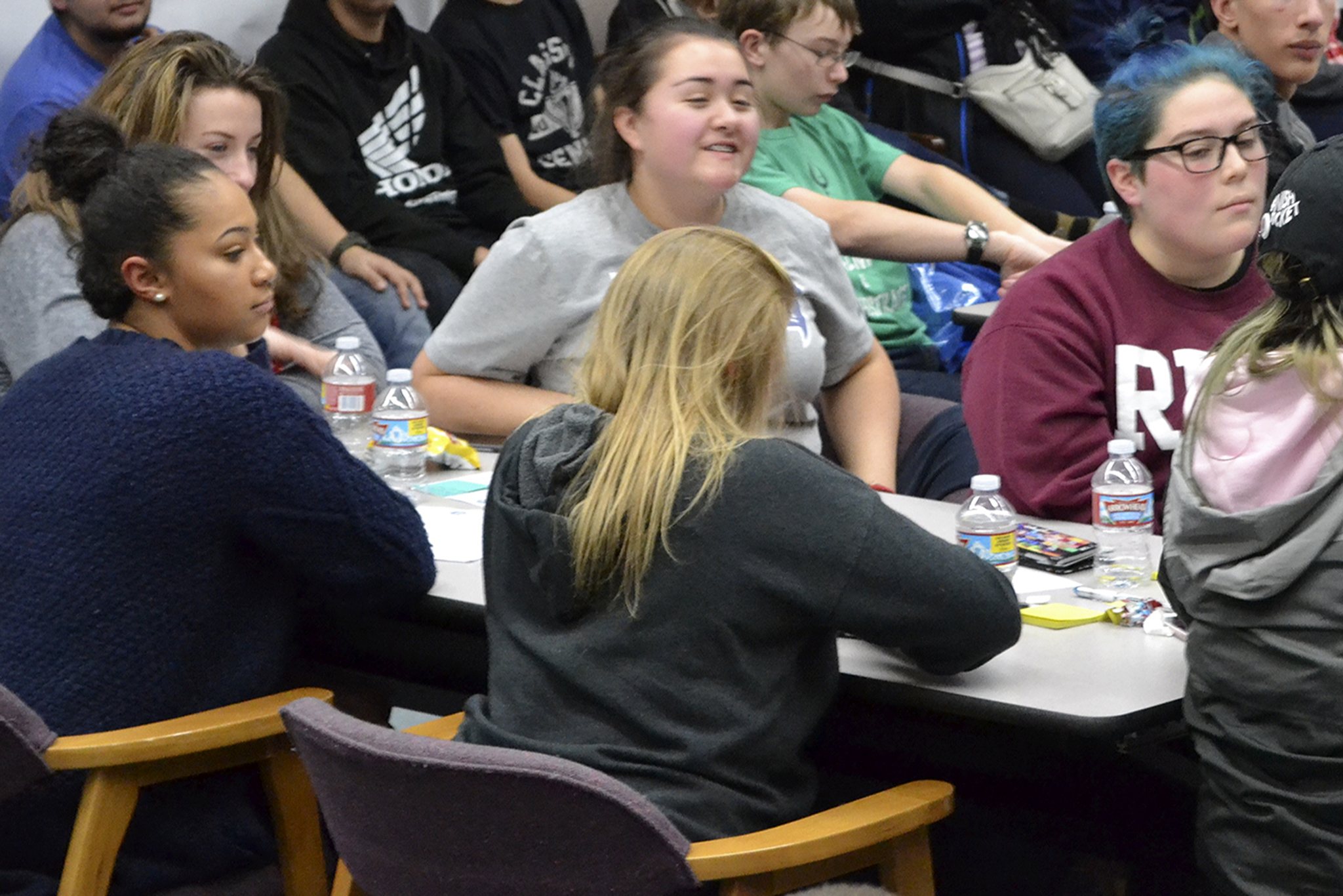 Chante Lee, Chloe Starkenburg and Keegan Samaniego sit with other friends at a table at the meeting for MG. (Steve Powell/Staff Photo)