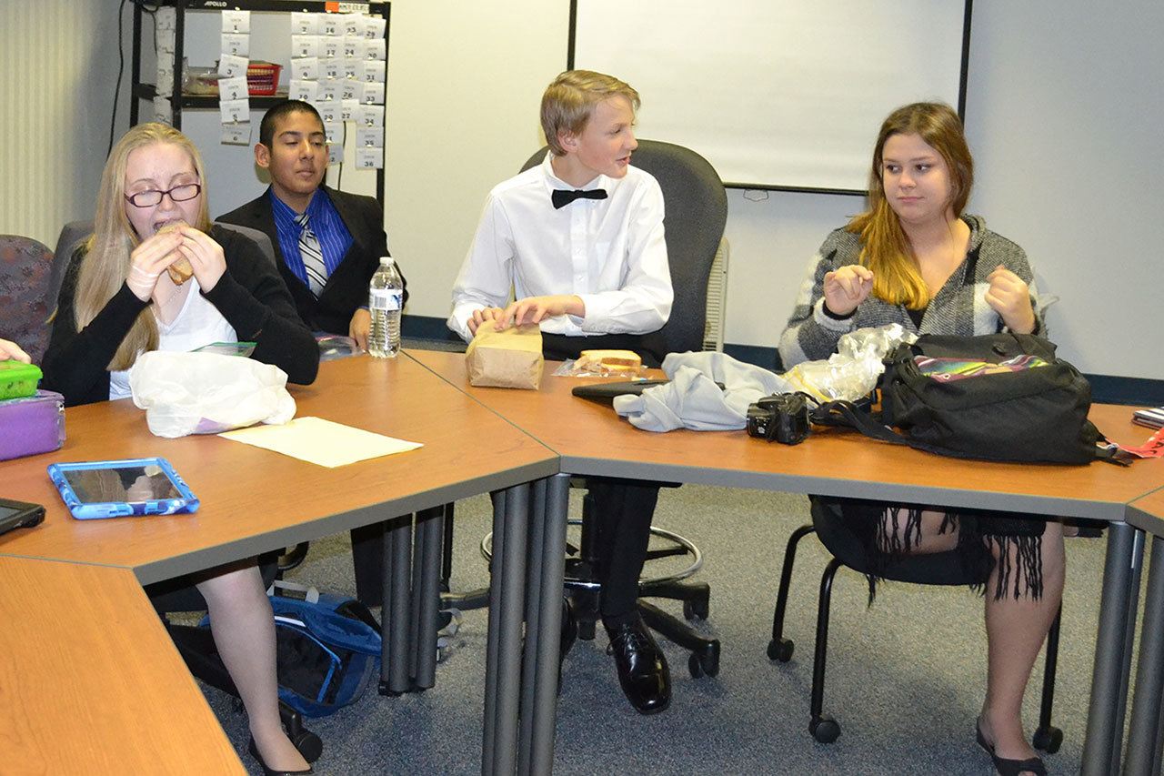 10th Street mock trial team members discuss the case during a lunch break. (Steve Powell/Staff Photo)