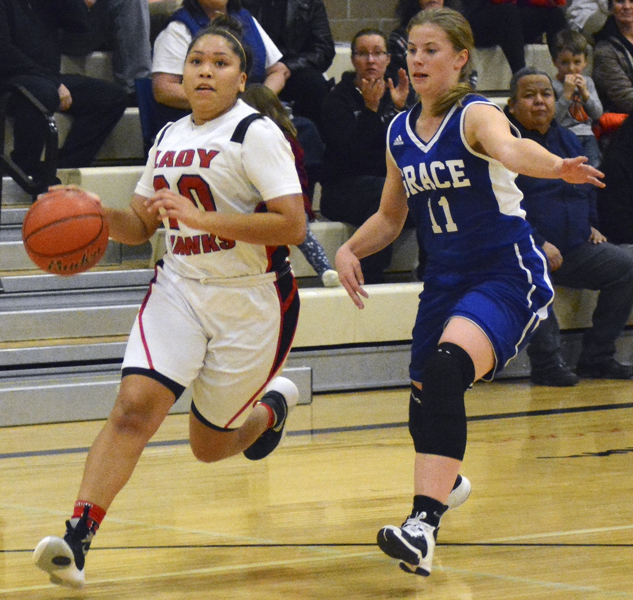 Tulalip’s Aliyah Jones, left, dribbles around Grace Academy’s Sam VanderWel. Brandon Adam/Staff Photo