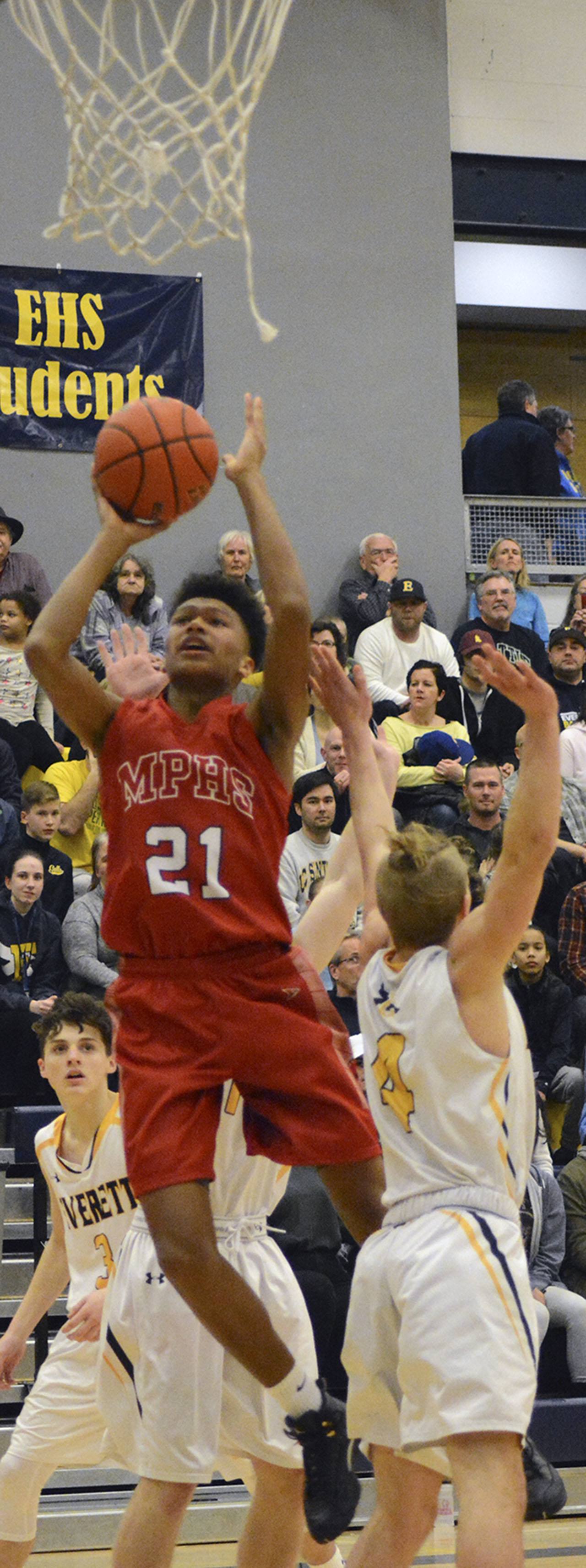Marysville-Pilchuck&rsquo;s RaeQuan Battle leaps above defenders in an attempt to score. Brandon Adam/Staff Photo