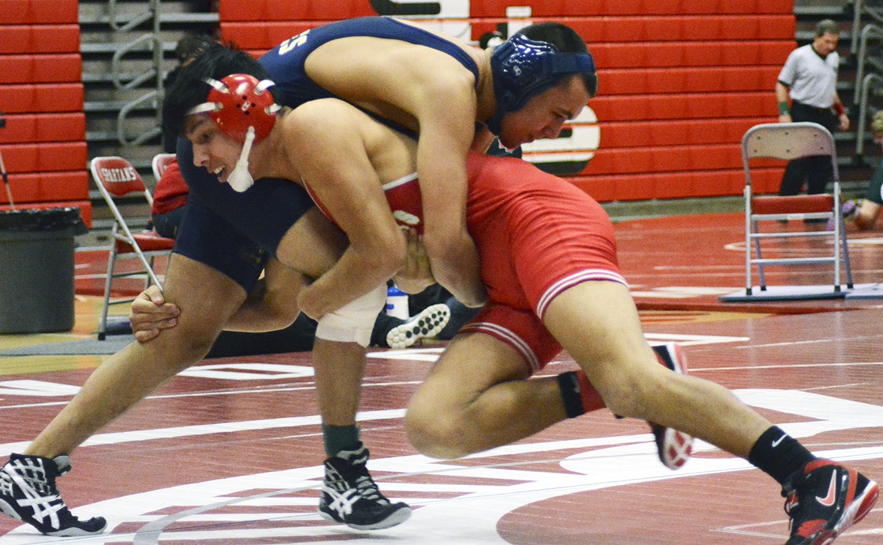 Keith Pablo of Marysville-Pilchuck (red) goes for the takedown against Arlington’s Manuel Munoz. Brandon Adam Staff/Photo