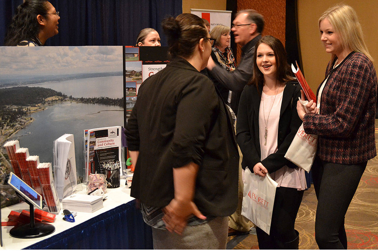 At a Tulalip Resort Casino booth, soon-to-be Washington State University graduates Laurel Thornlund and Kailey Larsen find out what type of work is available there. (Steve Powell/Staff Photo)