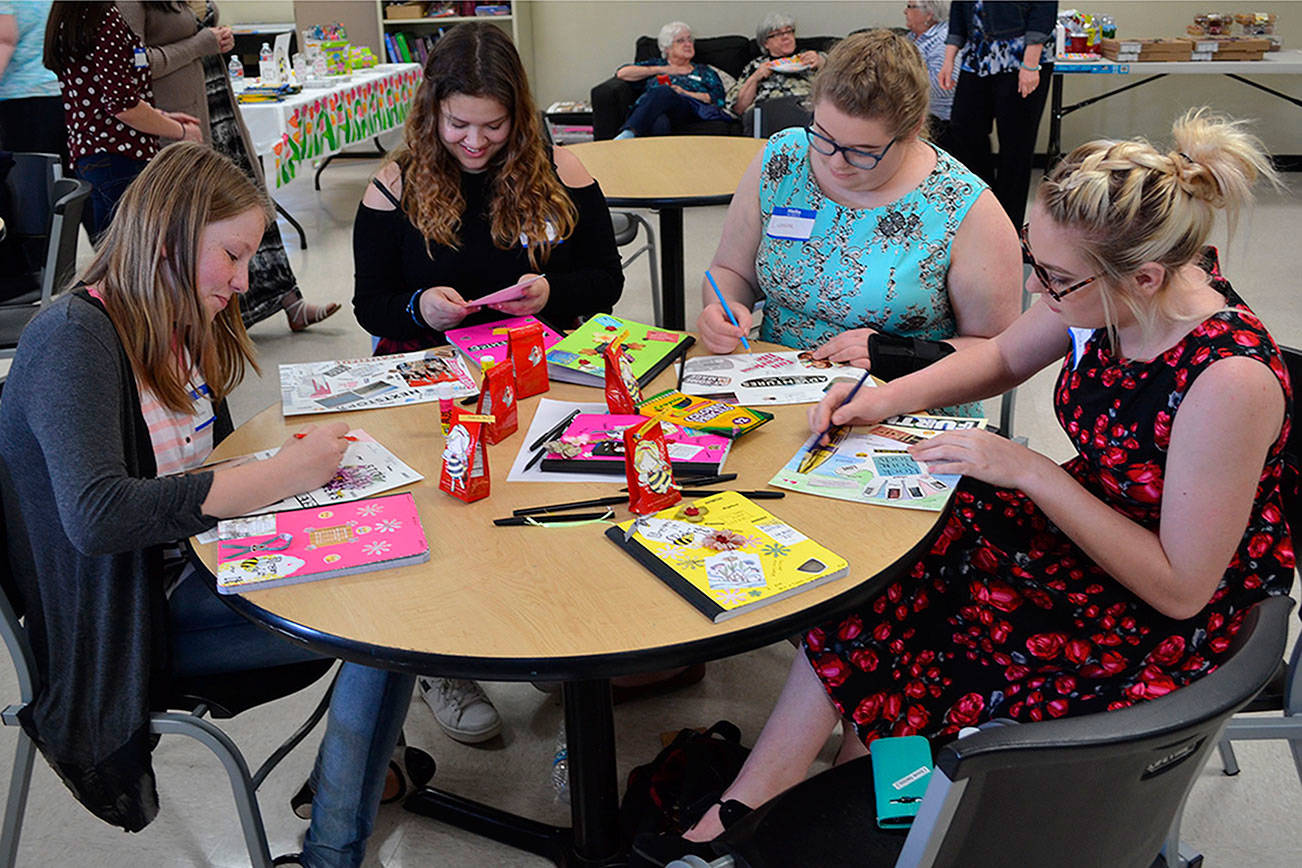 Victoria Wilde, left, Adda Garza, Eleanor Wilde and Alex Leavitt make Dream Boards about the careers they want, which also includes motivational sayings to keep them on track. (Steve Powell/Staff Photo)