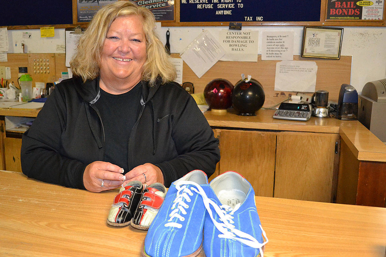 Manager Margie Wells shows the range in shoe sizes at Marysville’s Strawberry Lanes, from size 7 toddler to 17 men’s.