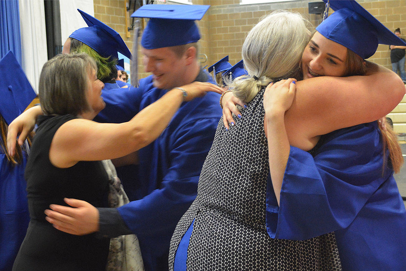 Graduation hugs show close bonds of Mountain View teachers, students