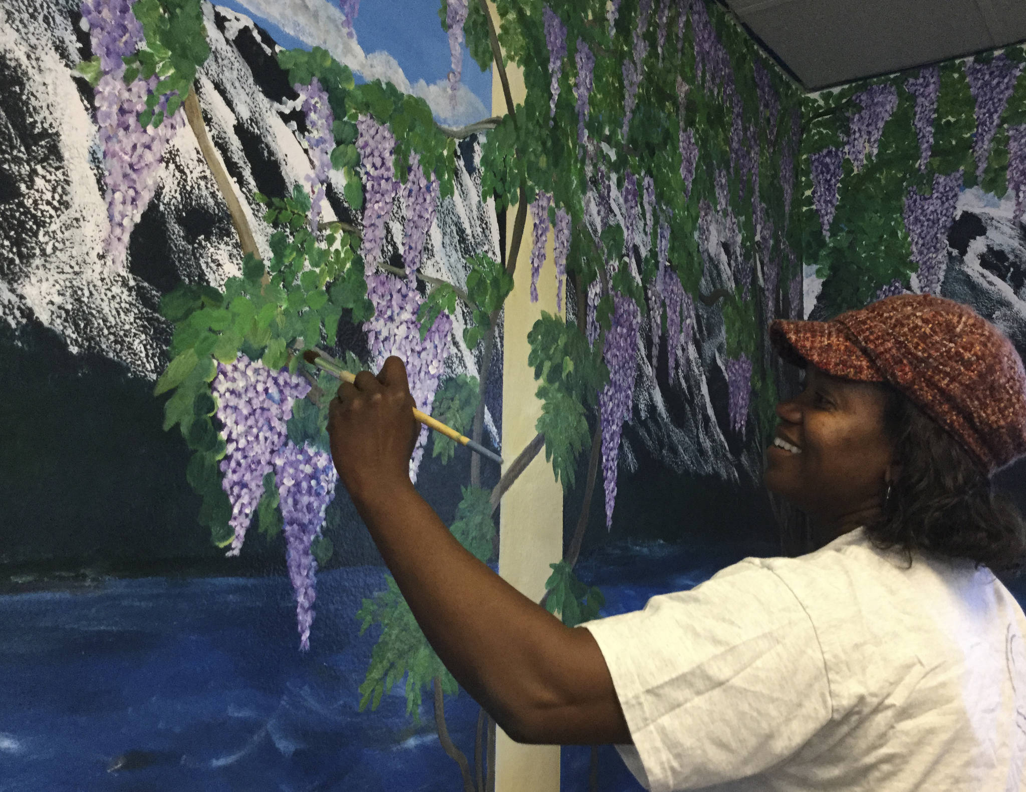 Douglas Buell/Staff Photo                                Marysville artist Aletha Tatge puts finishing touches on a mural room she created in the Attic Secrets Tearoom in Marysville.