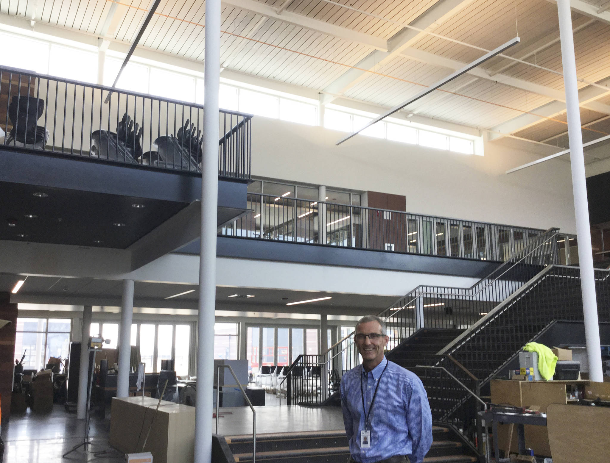 Schools Superintendent Michael Mack stands in the central commons area at the new Lakewood High School as teachers prepare their classrooms for the first day of school on Wednesday, June 6. Behind Mack on the second floor is the &ldquo;college, career and beyond&rdquo; wing, linked closely with the library.