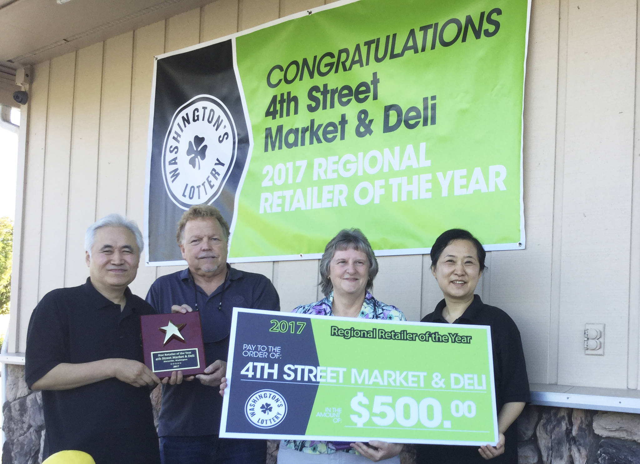 Douglas Buell/Staff Photo                                From left, 4th Street Market and Deli Owner Chang An, state Lottery regional sales manager Fil Gudmundson, Lottery district sales representative Susan Berger, store co-owner Mi An.