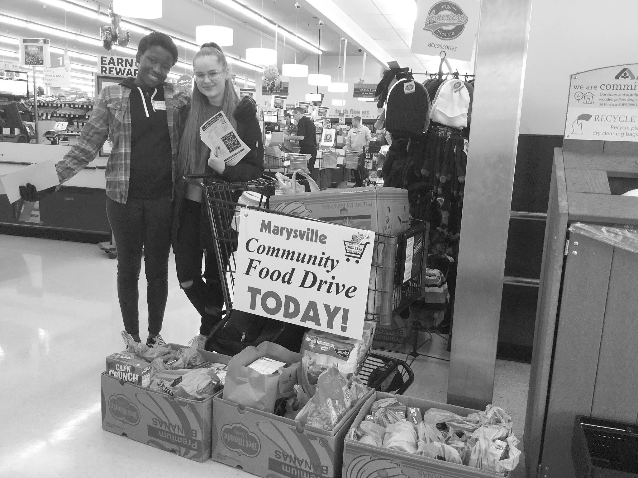 Aiche Danioko and Goda Katkute collect donations at the Albertsons during the All City Food Drive Nov. 4.