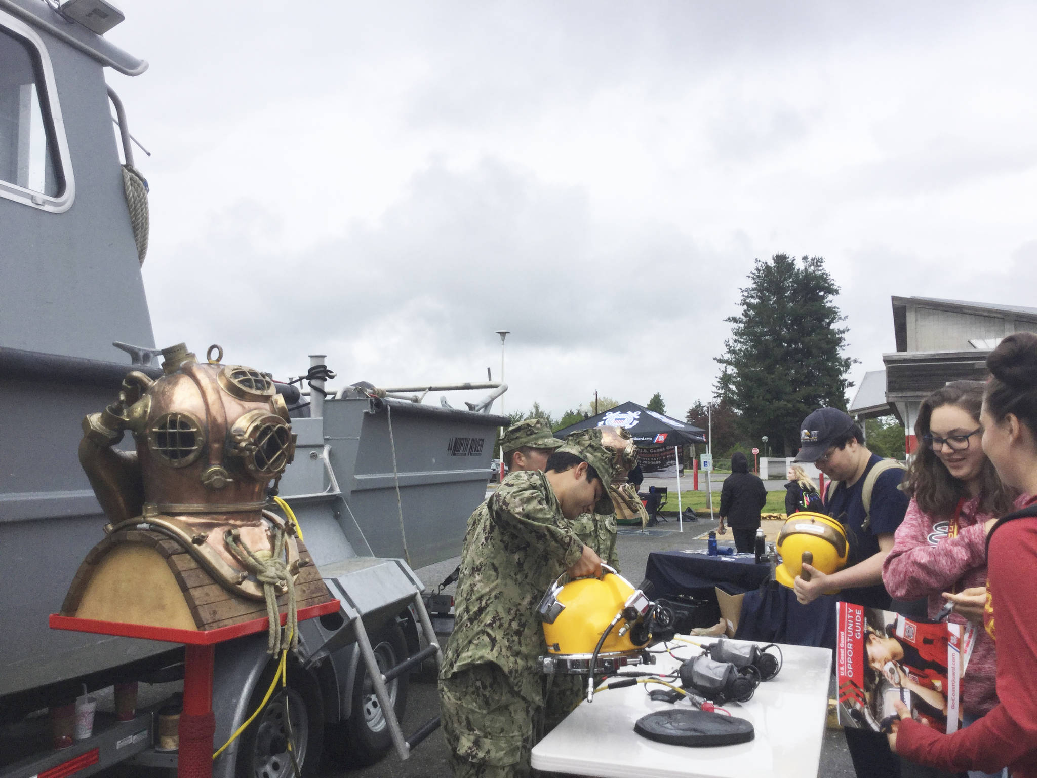 M-PHS sophomore twins Alissa and Kelsey Edge talk with Navy divers at Military Careers Day about how their training fits with with the careers the two are interested in.