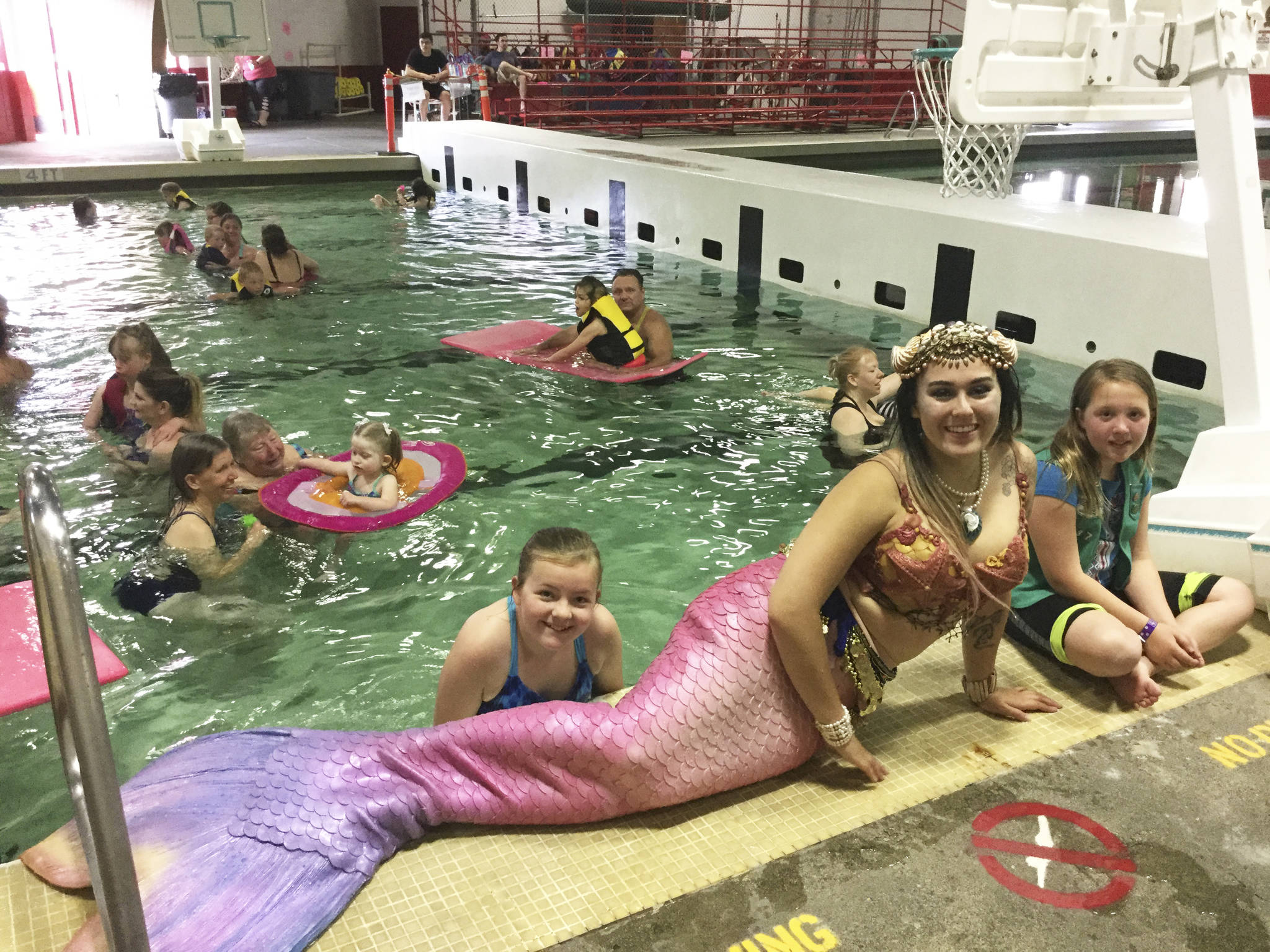 Avery Cagle (left) and Danica Jensen, pictured here with Seattle mermaid Tessie LaMourea. The two girls led their Arlington Junior Girl Scouts troop in hosting a “Swim With A Mermaid” party for special needs girls and their families Saturday at the Marysville-Pilchuck High School pool.