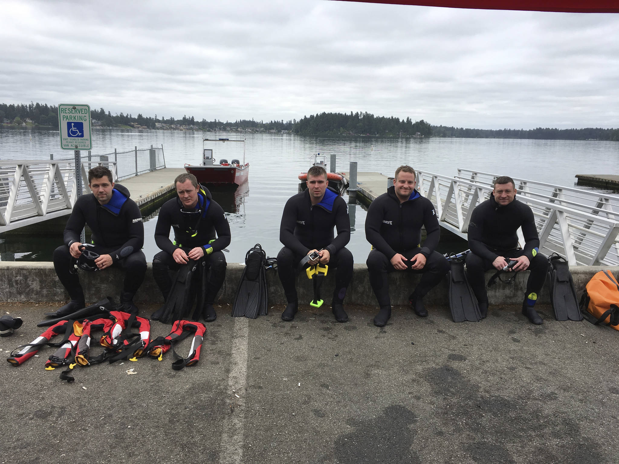 Arlington firefighters behind the departments new Technical Level Rescue Swimmers team take a break from training at American Lake in Pierce County. Pictured from left, Chris Peterson, Andrew Shannon, Sam Johnston, team leader and Capt. Kirk Normand, and Thomas Jackson.