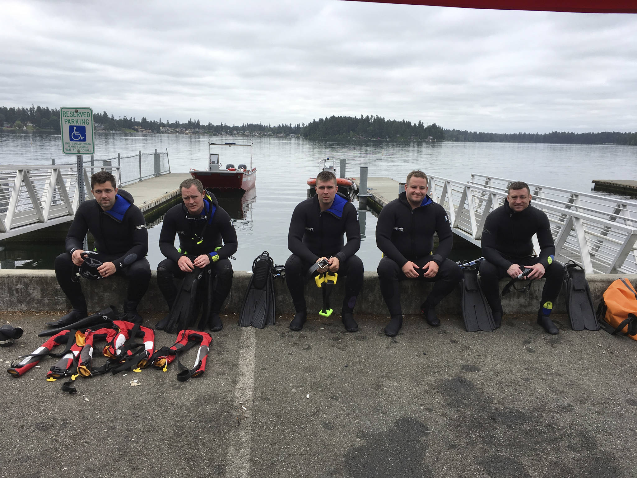 Arlington firefighters behind the department’s new Technical Level Rescue Swimmers team take a break from training at American Lake in Pierce County. Pictured from left, Chris Peterson, Andrew Shannon, Sam Johnston, team leader and Capt. Kirk Normand, and Thomas Jackson.