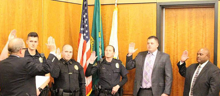 City Attorney Steve Peiffle swears in new Arlington police officers Shane Sharp, Dustin Bartlett, Rhonda Urton, Mike Ellis, and Mike Knight.