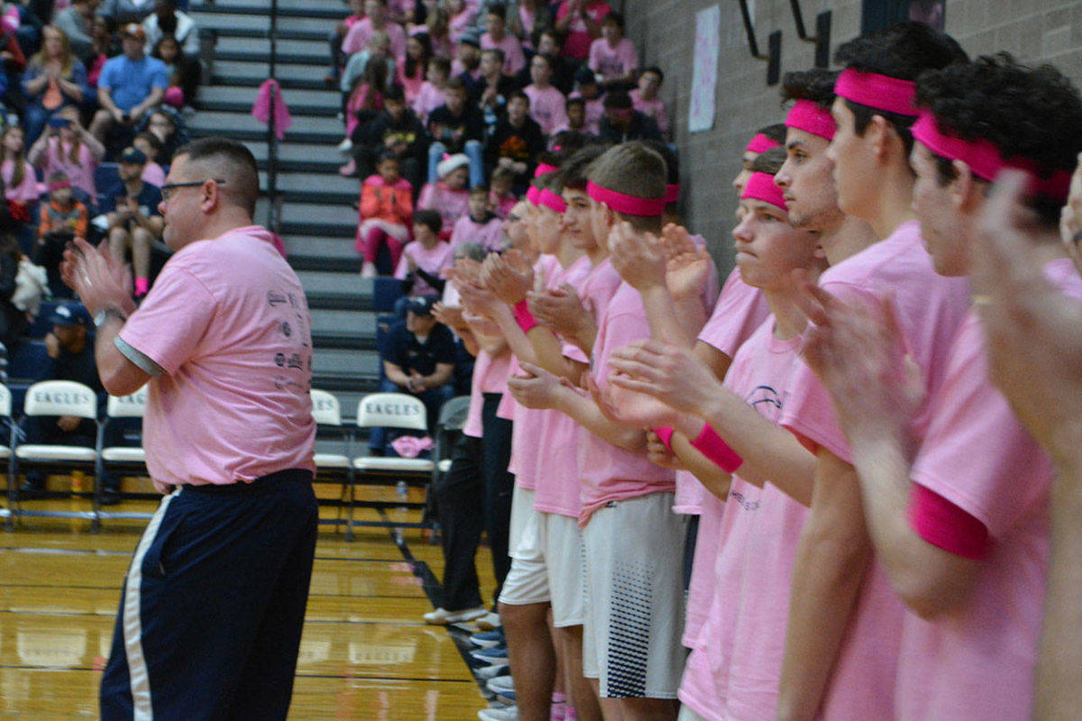 Arlington High School boys basketball coach Nick Brown applauds during the opening ceremony of last years Coaches vs. Cancer game. (File photo)