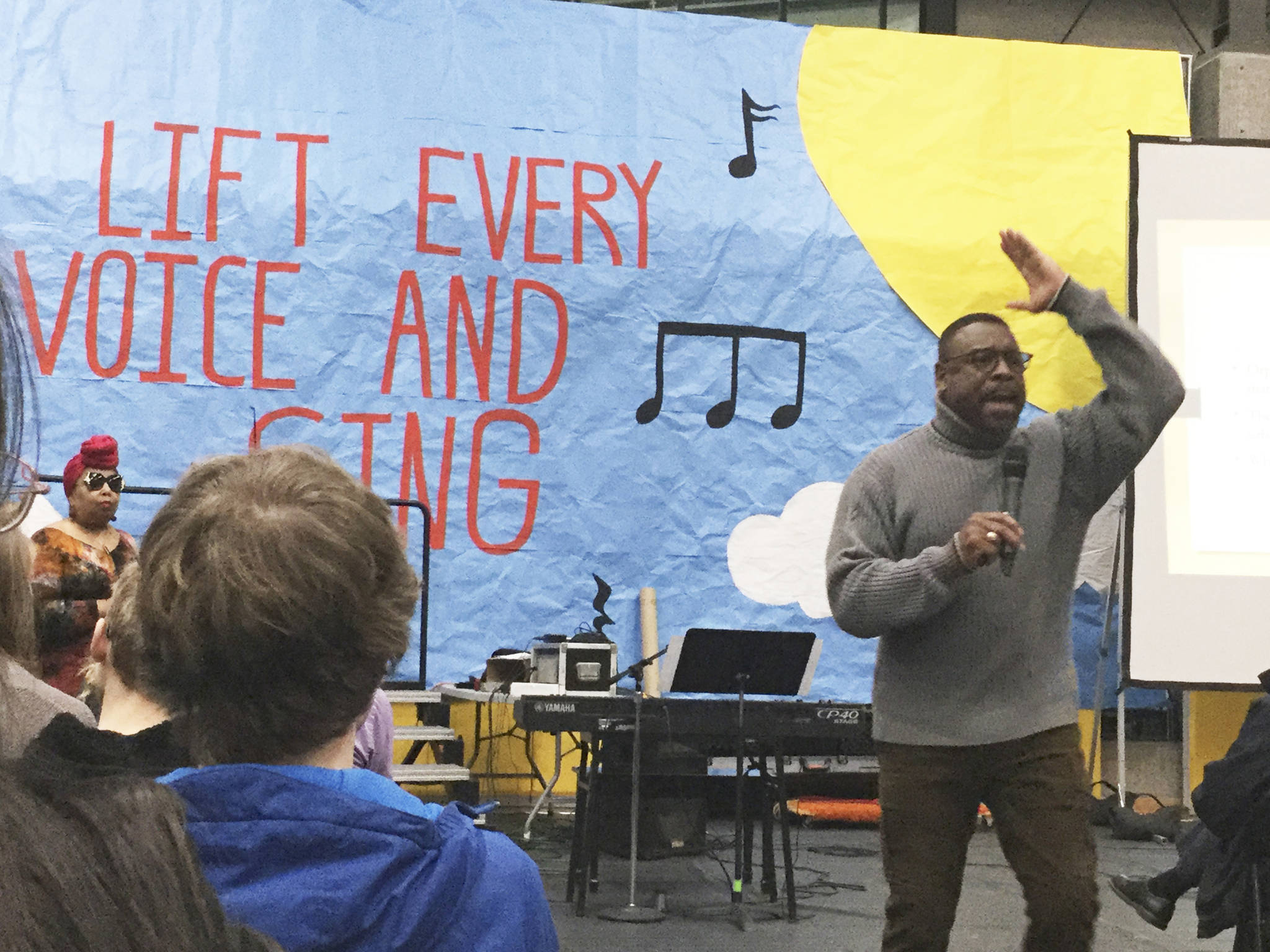 Stephen Newby talks about the influence of gospel music in Martin Luther King Jr.s life; seated in background is Seattle gospel singer Joy Jones.