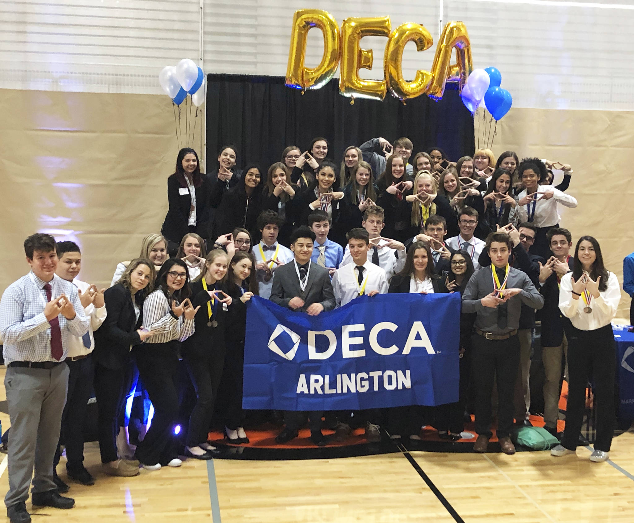 AHS DECA sets qualifying record at area competition, brings home most awards