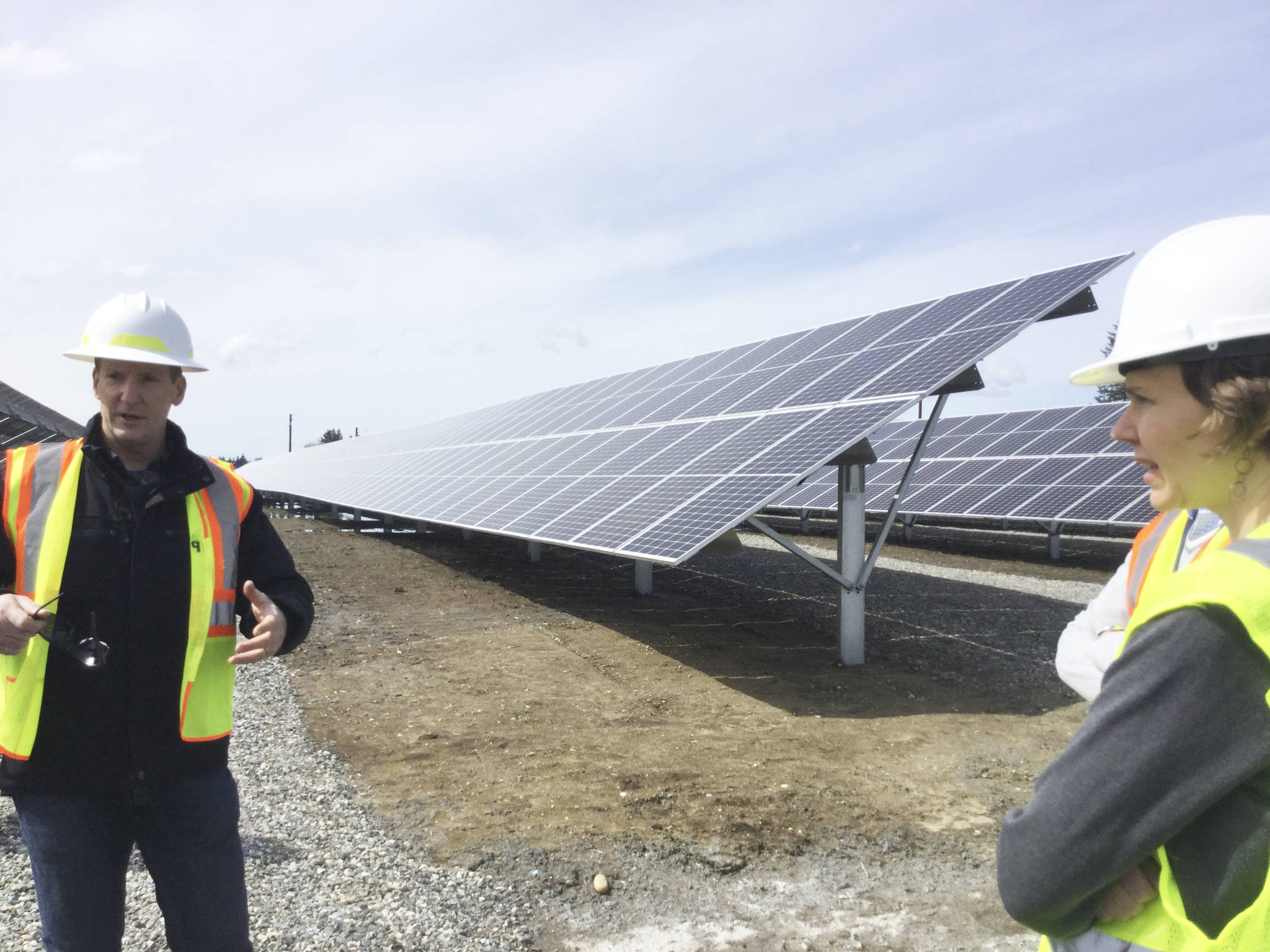 Snohomish County PUD project manager Scott Gibson and Community Solar program manager Suzy Oversvee stop by the new solar array installed at the Arlington Microgrid near the municipal airport. PUD will launch customer sales of solar energy units in the 1,620 panels on Earth Day, April 22.
