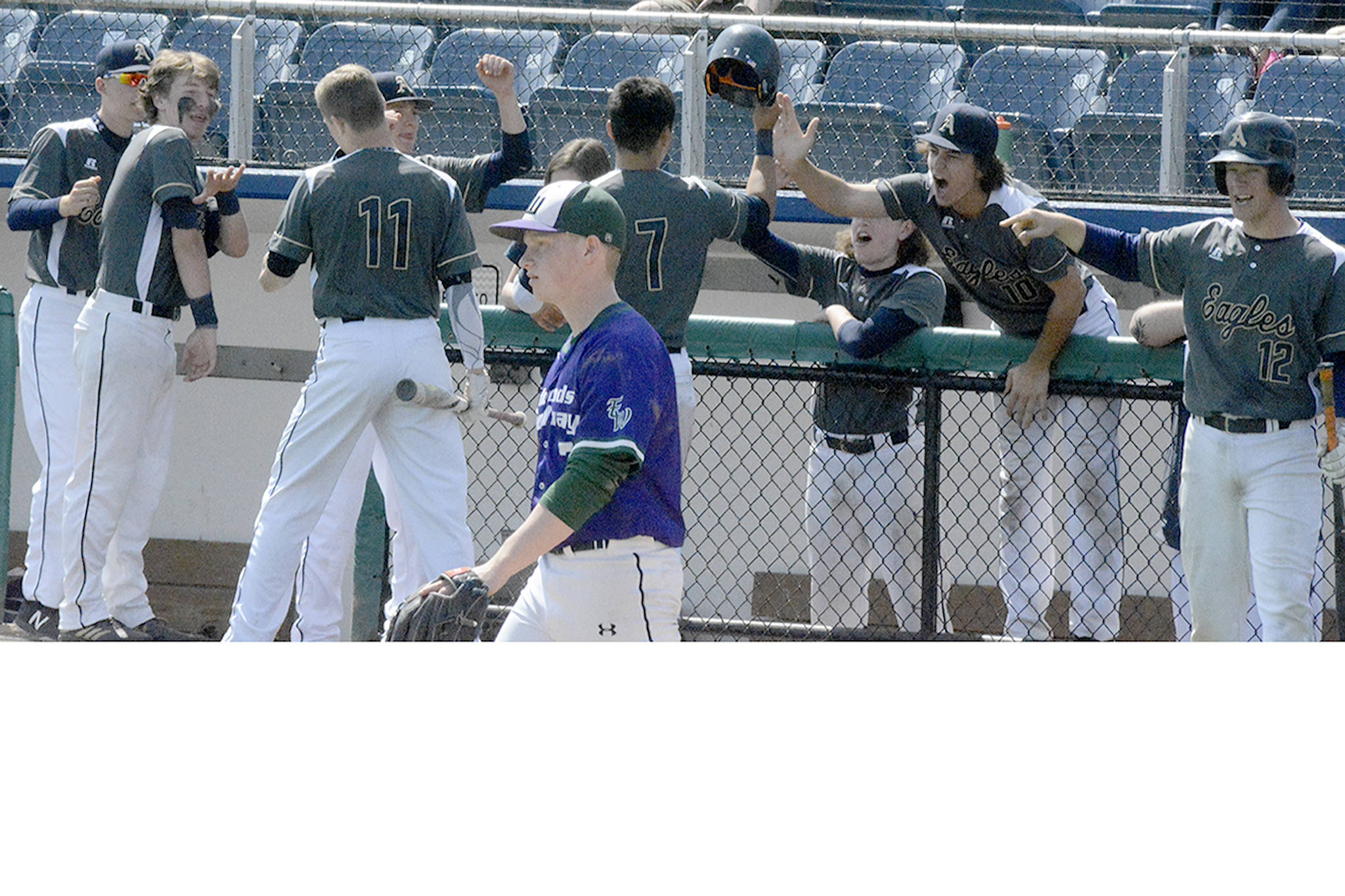 E-W’s pitcher walks away as Arlington’s boys baseball team celebrates their big inning.