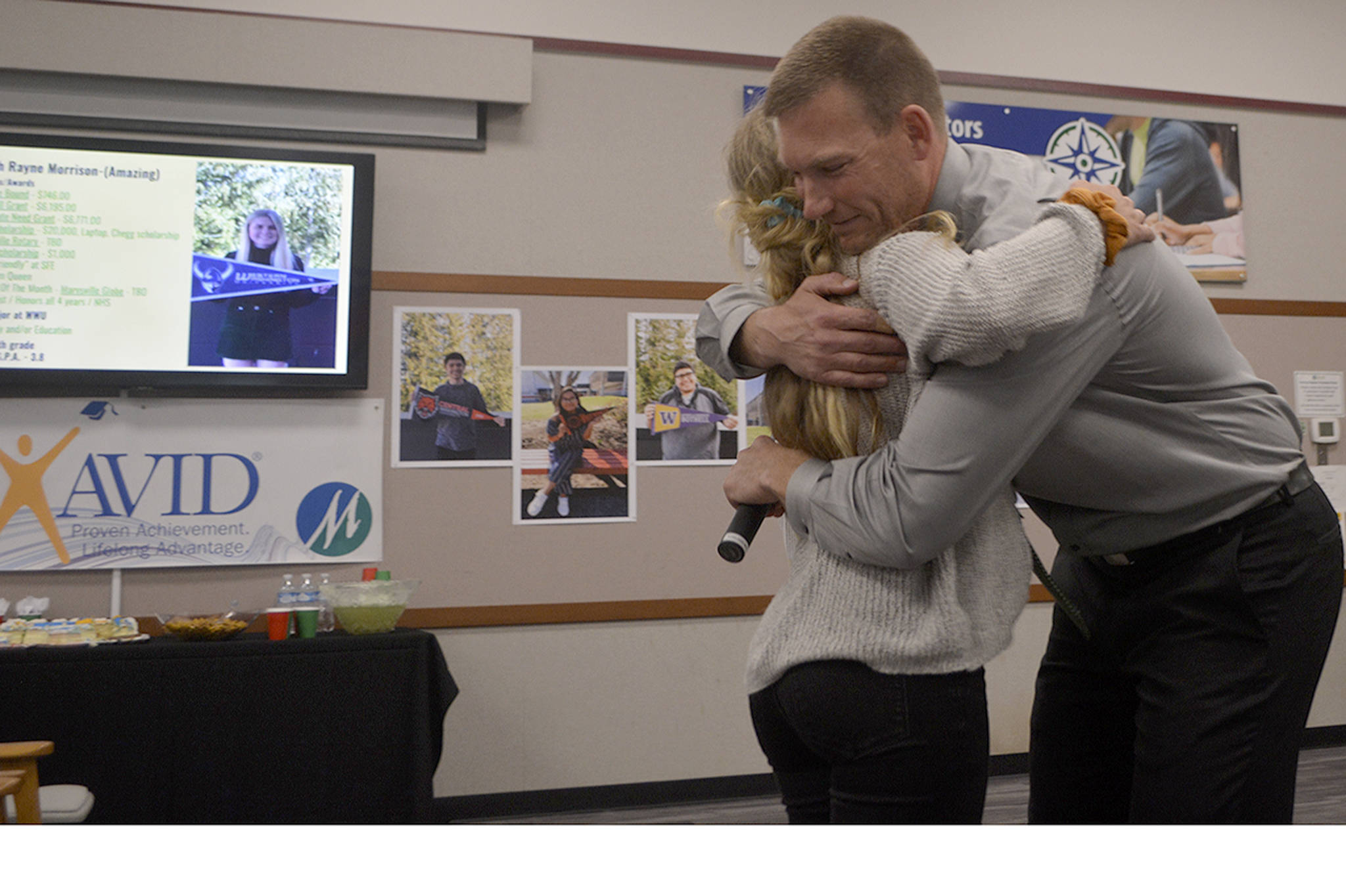 Marysville Getchell AVID teacher Corby Schuh gets a hug from Skyleigh Morrison. (Steve Powell/Staff Photo)