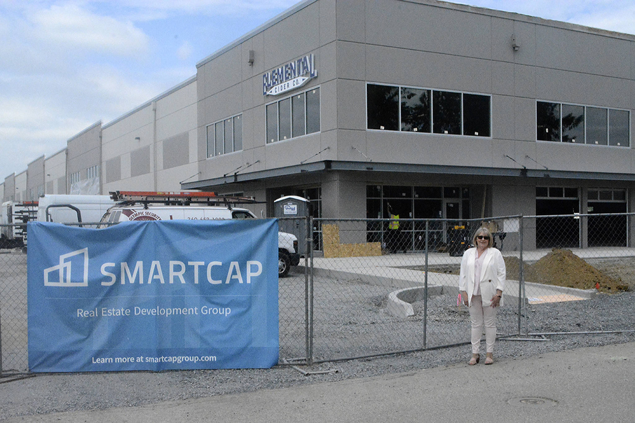 Arlington Mayor Barb Tolbert stands outside the SMARTCAP building, which is new to the MIC and will house three businesses with almost 300 employees. (Steve Powell/Staff Photo)