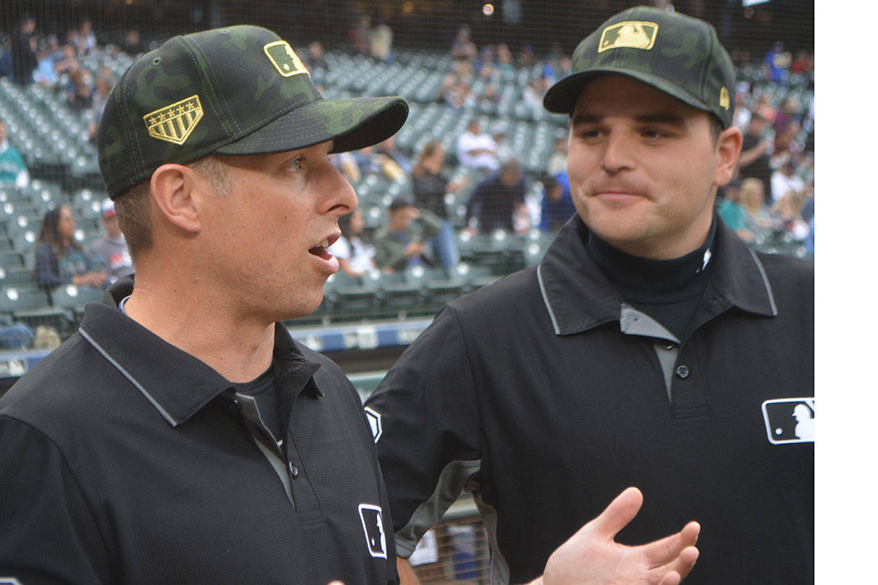 Tripp Gibson talks with another umpire who was working with him at the Mariners-Twins game.