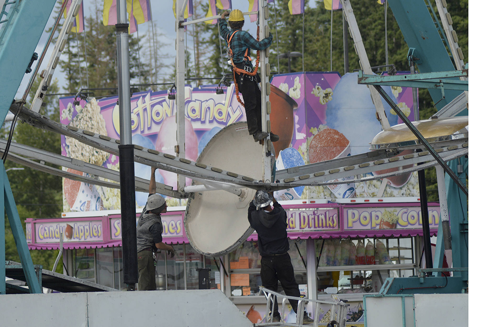 Workers set up the ferris wheel at the Marysville Tulalip Chamber of Commerce carnival Wednesday in the field between Home Depot and Cabelas. The carnival runs through Sunday, with proceeds going to chamber programs that help local businesses. A craft and vendor fair has been added this year to give adults something to do while the kids go on the rides. (Steve Powell/Staff Photo)