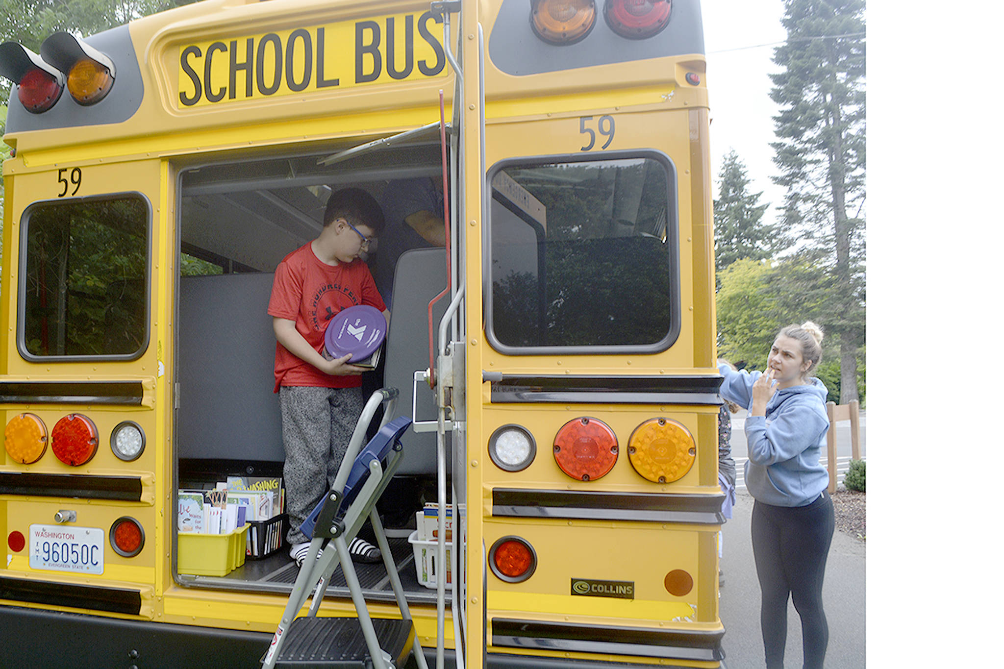 Gavin Anderson gets books at the Reading on the Road school bus.