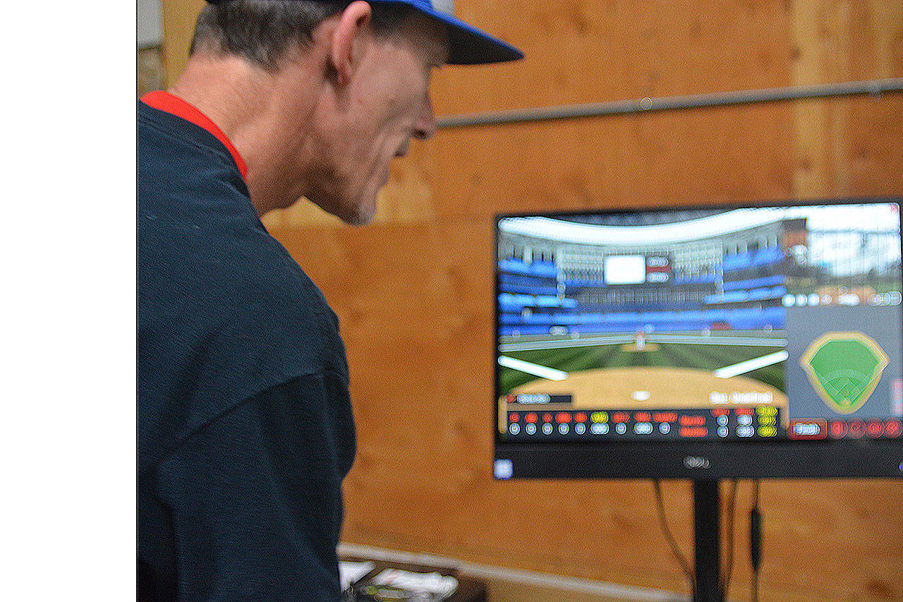 Steve Powell/Staff Photo                                 Rich Purdue looks at a monitor that shows the location of where hits in the batting case would land in any major league park.