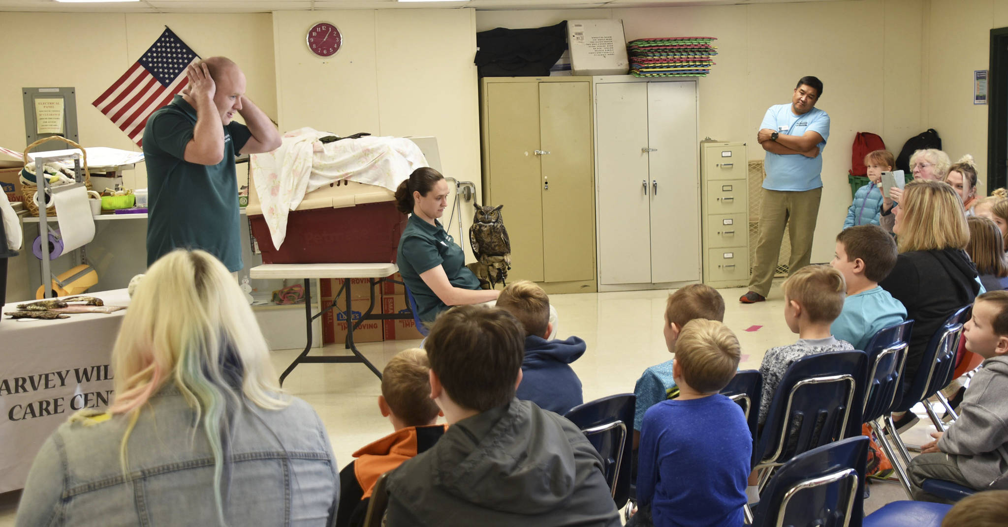 Staff from Sarvey Wildlife Care Center bring students up close with an owl to talk about the birds adaptability in nature.
