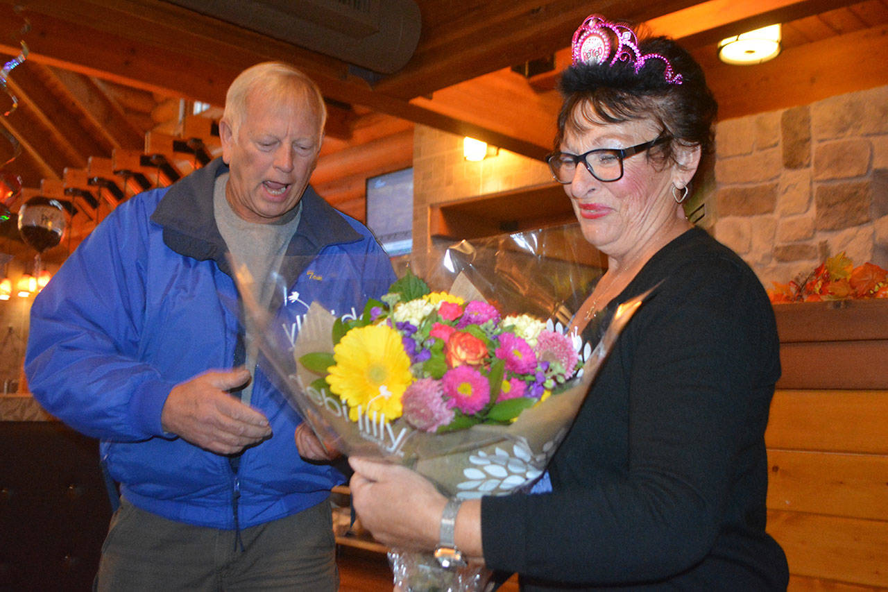 Laverne Moen served breakfast at Kiwanis Club meetings for 20 years. Here, Tom King, a Kiwanian that entire time, presents her with flowers on her last day. (Steve Powell/Staff Photo)