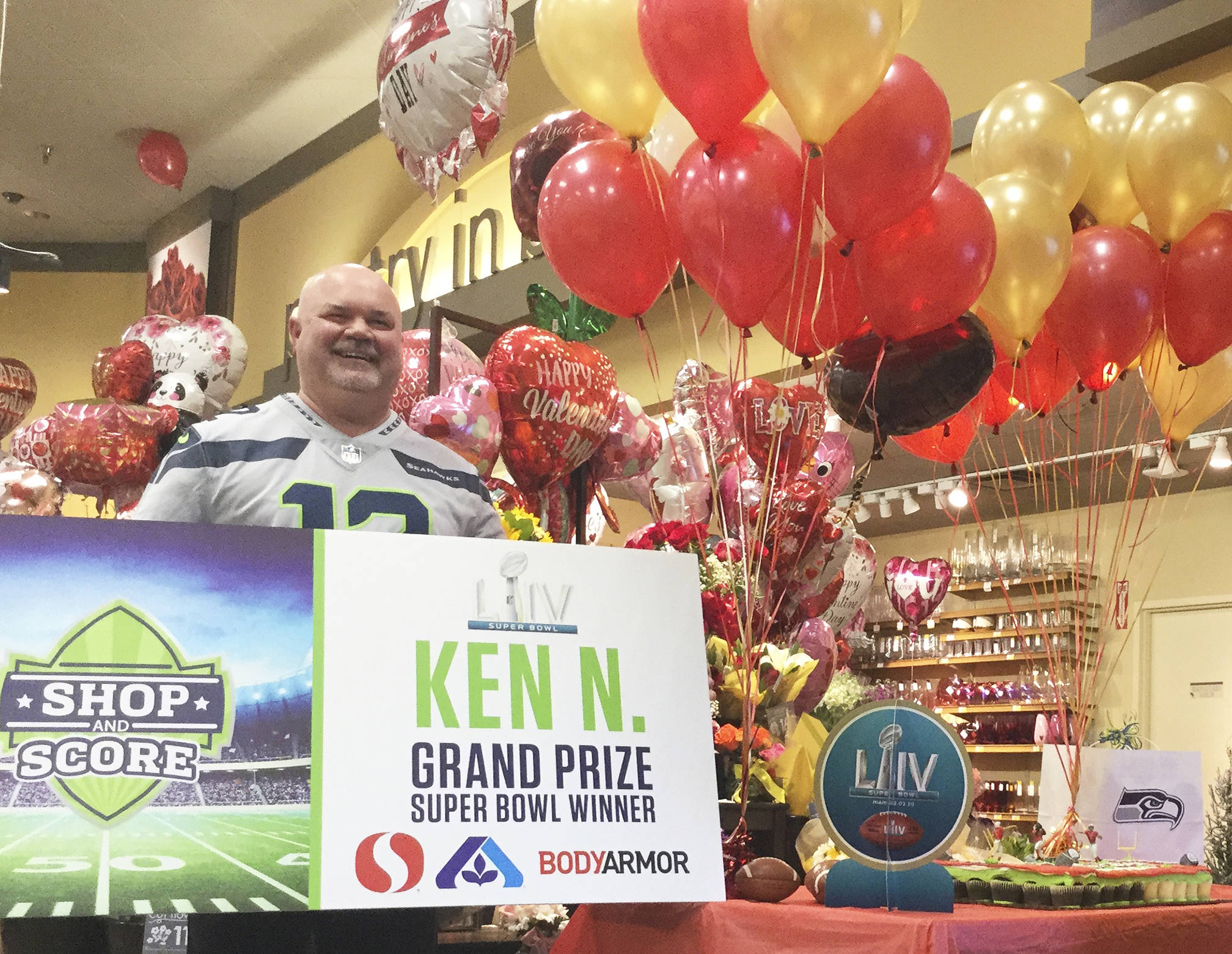 Arlington Safeway employee Ken Nobach celebrates winning two tickets and an all-expenses paid trip to this weekend’s Super Bowl LIV in Miami.