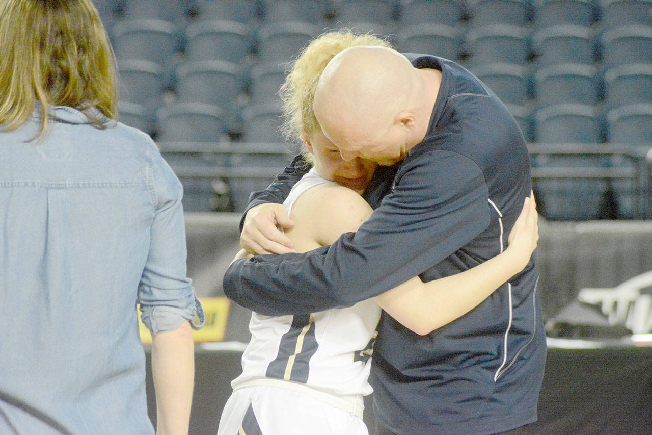 Coach Joe Marsh hugs senior standout Sierra Scheppele after the game.