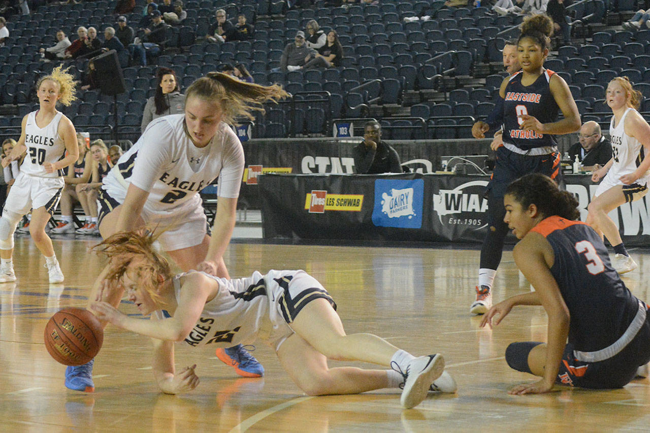 Josey Stupey dives for a loose ball in front of teammate Hailey Hiatt Saturday.