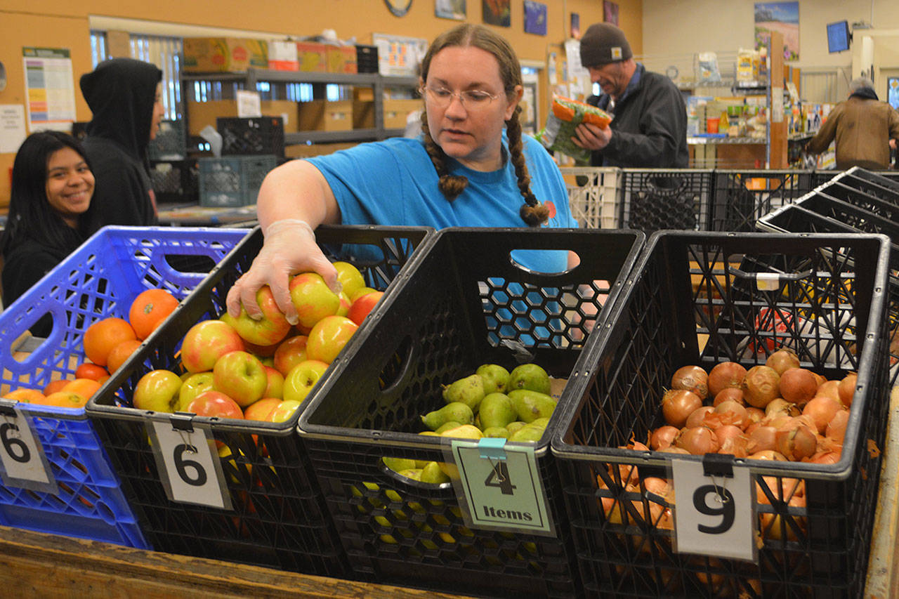 Food bank volunteers handle the produce.