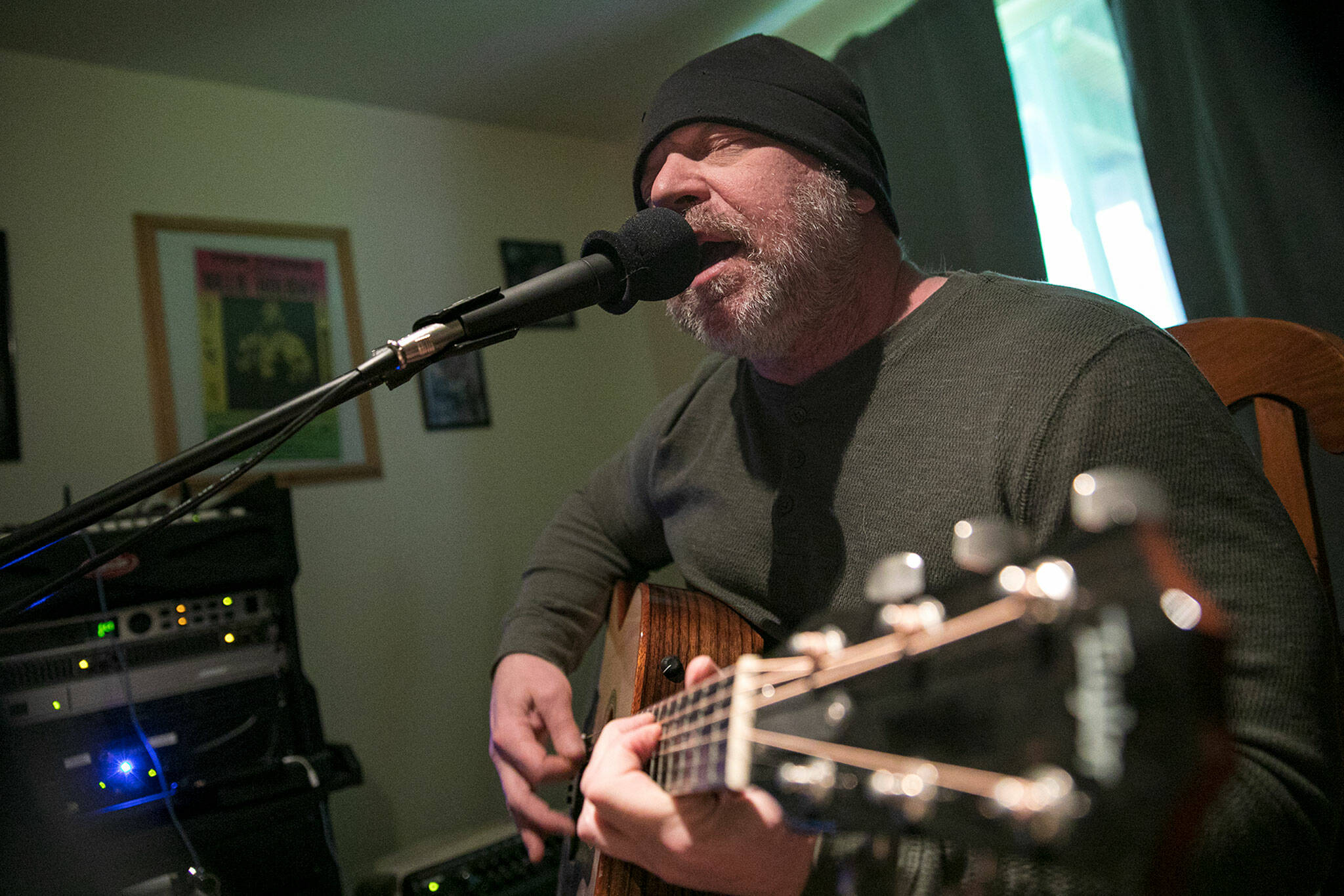 Nik Clovsky performs a song off his new album at his home in Marysville. (Ryan Berry / The Herald)
