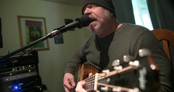 Nik Clovsky performs a song off his new album at his home Saturday, April 9, 2022, in Marysville, Washington. (Ryan Berry / The Herald)