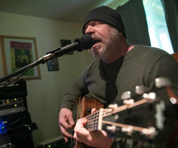 Nik Clovsky performs a song off his new album at his home Saturday, April 9, 2022, in Marysville, Washington. (Ryan Berry / The Herald)