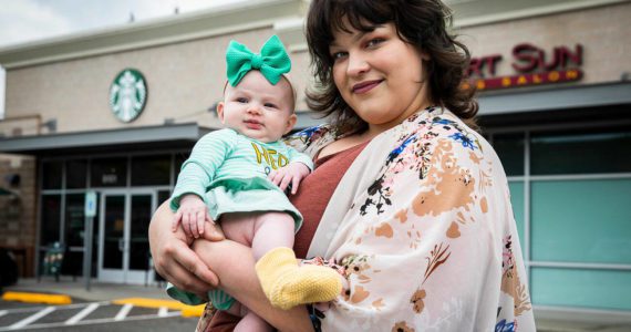 Amber Weaver, who has worked at the Lakewood Crossing Starbucks for 5 years, with her daughter Melody, outside of her workplace on Thursday, Sept. 22, 2022 in Marysville, Washington. (Olivia Vanni / The Herald)