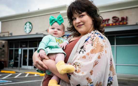 Amber Weaver, who has worked at the Lakewood Crossing Starbucks for 5 years, with her daughter Melody, outside of her workplace on Thursday, Sept. 22, 2022 in Marysville, Washington. (Olivia Vanni / The Herald)